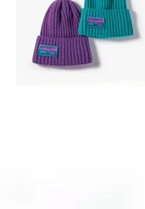 Detail of purple and teal ribbed knit beanies featuring a stylish rectangular cloth patch