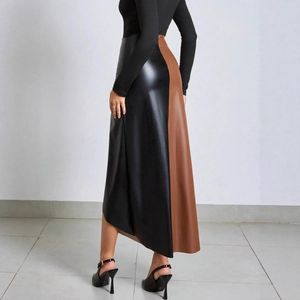 Detail of high-waist faux leather skirt featuring black and brown patchwork design