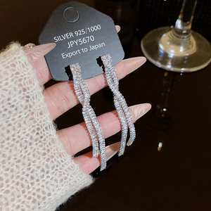 Long tassel S925 silver earrings with shimmering zirconia on a black display card