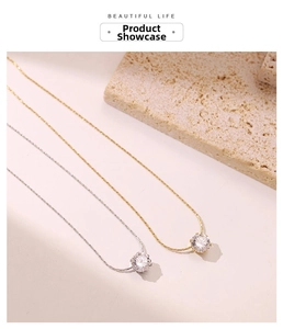 Detail of silver and gold pendant necklaces with zircon crystals on stone base