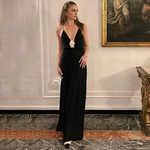 Close-up of white floral applique on elegant black V-neck backless chiffon maxi dress