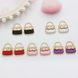 Flat lay of colorful enamel handbag charms with pearls for DIY jewelry accessories