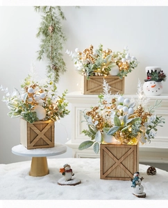 Mini Christmas tree in wooden box with gold berries, green leaves and LED lights