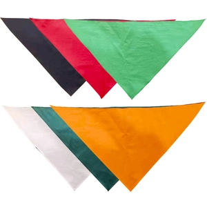 Flat lay of solid color cotton pet bandanas in black, red, green, white, and orange