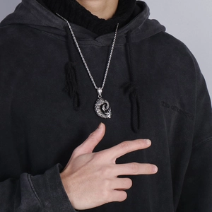 Silver dragon pendant with twist chain necklace in punk style worn by a male model
