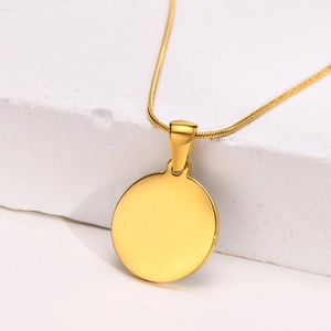 Macro view of a 18K gold plated titanium necklace with a black round pendant on stone