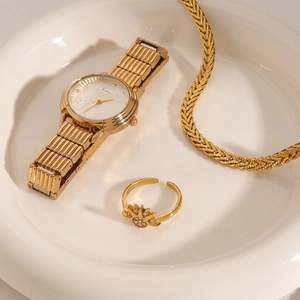 Golden watch set with sunflower diamond ring and thick braided chain in a ceramic tray