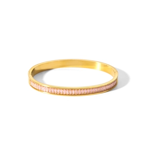 Detail of gold-plated hinged bangle featuring rectangular pink zircon pavé setting