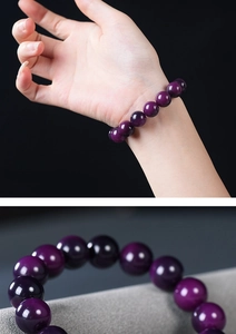Macro detail of deep purple bodhi seed prayer beads bracelet with smooth polished finish