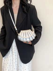 Silver shell-shaped crossbody bag with pleated metallic finish and pearl chain detail