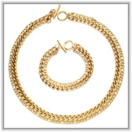 Detail of gold floral chunky chain necklace and bracelet set with T-bar toggle closure