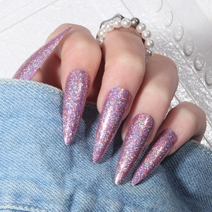 Macro shot of long pink laser glitter press-on nails with shiny holographic finish