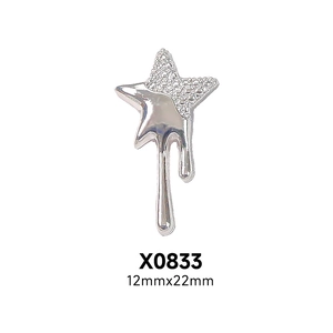 Detail of silver asymmetric star nail charm with textured and molten metal effect, 12x22mm