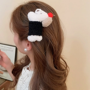 Close-up of a plush bear hair clip featuring soft fabric texture and a cute cartoon design