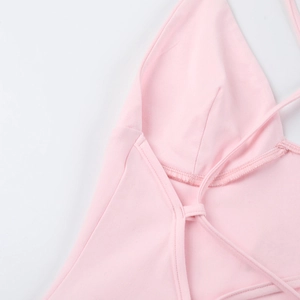 Detailed view of pink halter neck jumpsuit with elastic texture and fine stitching detail
