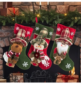 Detailed view of three Christmas stockings with Santa, snowman and reindeer 3D dolls