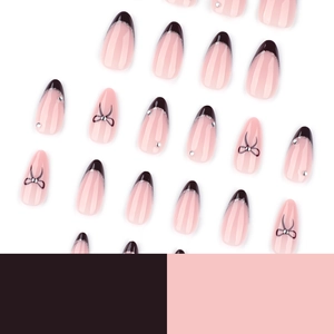 French style nude and black press-on nails with silver glitter and black bow accents