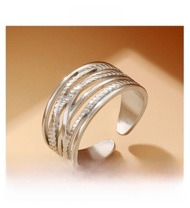 Detailed view of multilayer crisscross silver ring featuring textured braided lines