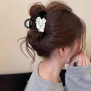 Detail view of a cute cartoon dog claw clip on hair for a stylish hair arrangement