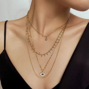 Layered gold titanium steel necklace featuring bohemian charms and an evil eye pendant