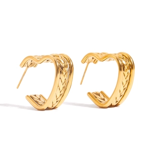 Detailed macro view of 18K gold stainless steel hoop earrings with woven texture