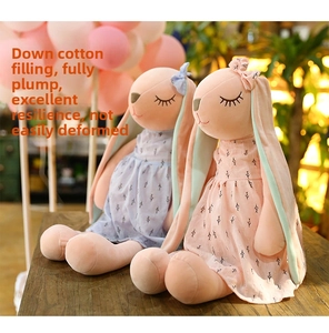Close-up of plush bunny dolls with floral dresses and down cotton filling detail
