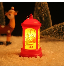 Close-up of a red Christmas lantern with Santa Claus motif and warm glowing LED light