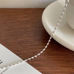 Minimalist S925 sterling silver anklet featuring polished olive beads on a dark wood surface