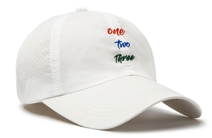 Close-up of colorful 'one two three' embroidery and breathable laser-cut holes on white cap