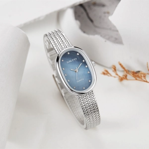 Detail view of oval blue mother-of-pearl dial with silver mesh strap quartz watch