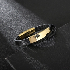 Dettaglio di bracciale in pelle multistrato con design a stella in acciaio dorato