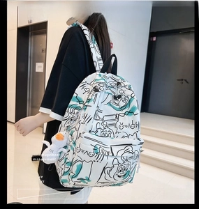 Graffiti printed backpack featuring comic characters and a cute plush duck pendant