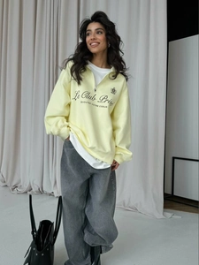 Pale yellow half-zip sweatshirt with letter print and gray wide-leg jeans outfit