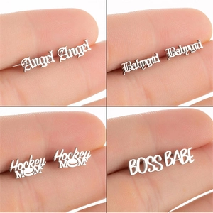 Macro detail of gothic style Angel and Babygirl stainless steel stud earrings set