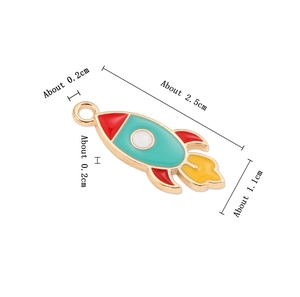 Macro shot of colorful enamel rocket pendant with detailed dimensions on white background