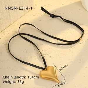 Detailed view of large gold heart pendant on 104cm black leather cord necklace