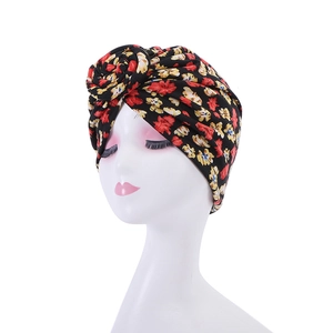 Detail of vintage floral turban with a 3D rosette and soft pleated polyester fabric