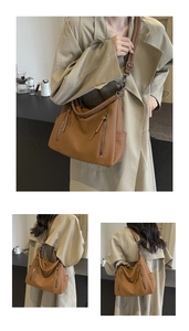 Detail of soft brown PU leather tote bag with vertical decorative zippers and metal hardware