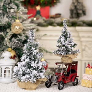 Mini snow-flocked Christmas trees with burlap base and vintage red metal car decoration