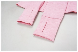 Detail of pink brushed athletic jacket sleeves featuring thumbhole cuffs and flatlock seams