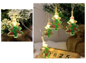 Detailed view of LED Christmas tree string lights with festive patterns on snowy pine branches