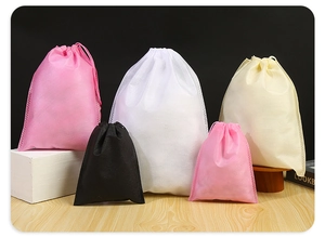 Macro detail of various sized non-woven drawstring bags showing texture and vibrant colors