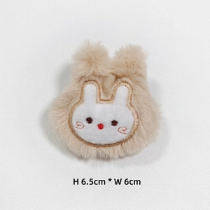 Detail of plush bunny accessory featuring embroidery and 6.5cm by 6cm dimensions