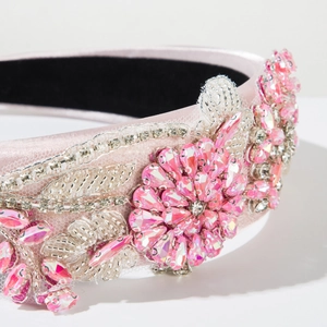 Dettaglio ravvicinato del cerchietto rosa con fiori di cristallo 3D e strass brillanti