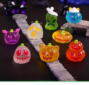 Detailed view of colorful Halloween miniature resin pumpkin and ghost figurines for DIY decor