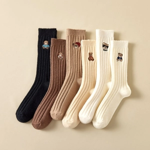 Detailed knit texture and cute bear embroidery on various colored mid-calf winter socks