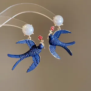 Elegant pearl swallow and red rose drop earrings with blue enamel in a vintage style