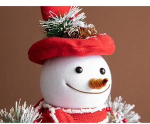 Close-up of a white foam snowman with red felt hat and knitted scarf for Christmas decor