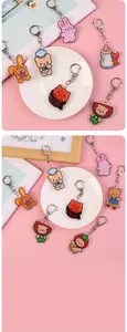 Close-up of cute acrylic cartoon bear keychain with colorful charms and metal hook