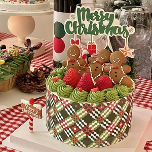 Detailed Christmas cake view with gingerbread men, fresh strawberries and festive toppers